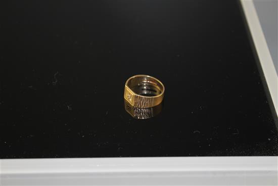 A modern 9ct gold and diamond chip set signet ring, with textured shoulders, size R/S, gross 3.9 grams.